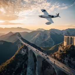 a plane flying over a bridge in the mountains
