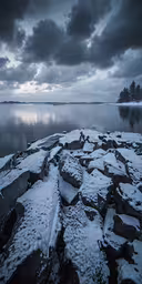 a snowy landscape on the shore of a lake