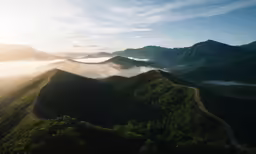 an aerial view of mountains covered with mist