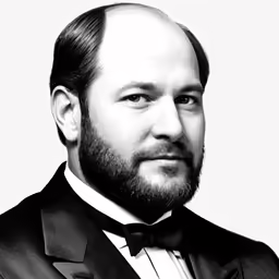 an old photo of a bearded man wearing a suit and bow tie