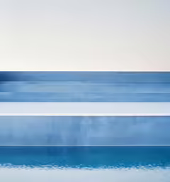 a very nice blue and white pool with some steps