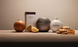 three bottles, two soaps and two oranges are shown