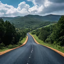 the road is going to nowhere with green hills in the distance