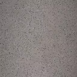 a concrete background that is gray with little black dots