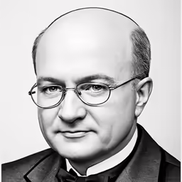 a man with a bald head in a suit and tie