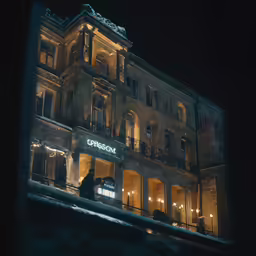 the building at night with people standing outside