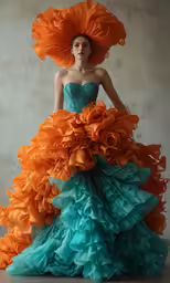 a woman dressed as a flamer in a dress with an orange plume on her head