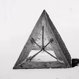 a triangle is seen in the snow with two forks