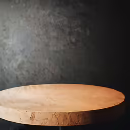 an empty round table on a black background