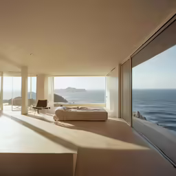 an open living room overlooks the ocean