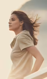 a woman in an all beige top is standing next to a fence