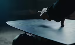 a person pushing a table into the dark