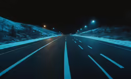 a city street at night lit up by street lights