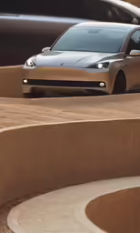 a sleekly designed car is parked outside
