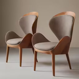 two chairs sitting next to each other on top of a gray floor