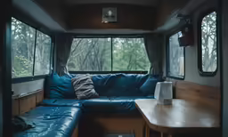 blue couch on top of the coffee table and inside a trailer
