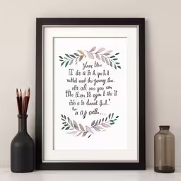 a photo with some watercolor paints and a small vase,there is a print that has a quote above it
