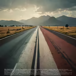 an empty road with mountains in the background