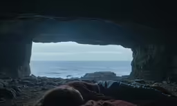 a person sleeping in the middle of a cave at night