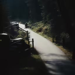 a person riding on an old car down the road