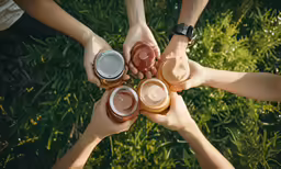 group of young people holding drinks with jars in the shape of a star