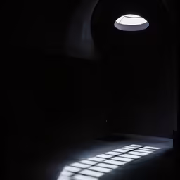 dark photograph of sunlight streaming through a window in a room
