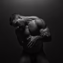 a bodybuilde posing in the dark
