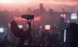 a person with cameras in the middle of a crowd