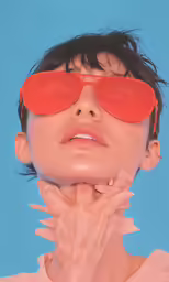 a person wearing red sunglasses in front of a blue background
