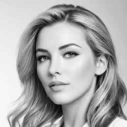 woman in black and white posing with hand on neck