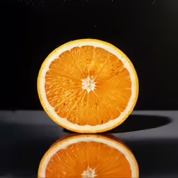 an orange on a reflective surface with reflections
