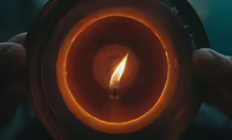 a closeup photo of someone holding an oil - lamp