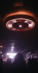 people standing in a dark room with their lights on