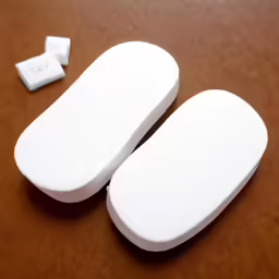 three white objects that are placed on the table