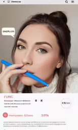 a woman looking up while she is biting into something