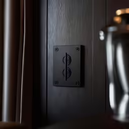 the interior of a room, showing the wall - mounted square knob