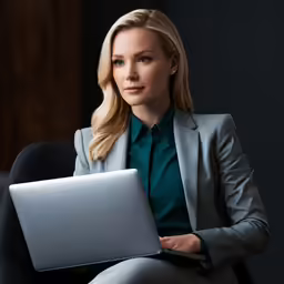 a woman sitting down using a laptop