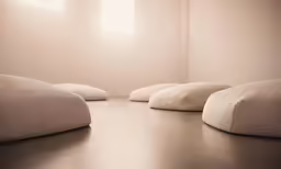 a group of four white cushions next to each other