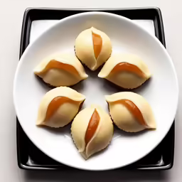 a white plate topped with four pastry pieces