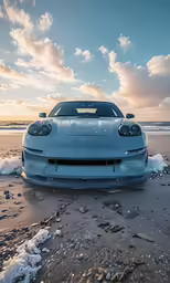 a very shiny car parked on the beach by the ocean