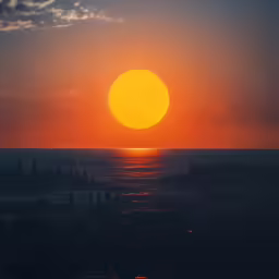 the sun is setting over the ocean and a body of water