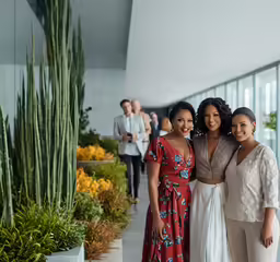 two ladies and a man posing for a photo together