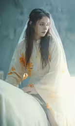 woman in medieval dress sitting down on the bed