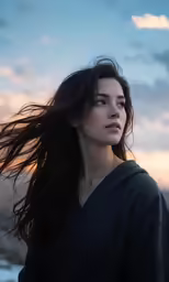 a woman with dark hair in the wind