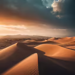 an evening view of desert sand and clouds