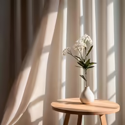 a small vase with flowers on a wooden table