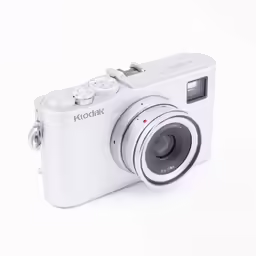 a white camera sitting on top of a table