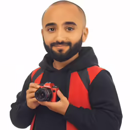 a man is holding a camera and smiling
