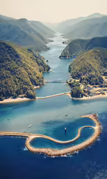 the aerial view of a bay surrounded by hills