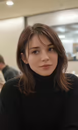 woman in black sitting in an office lobby